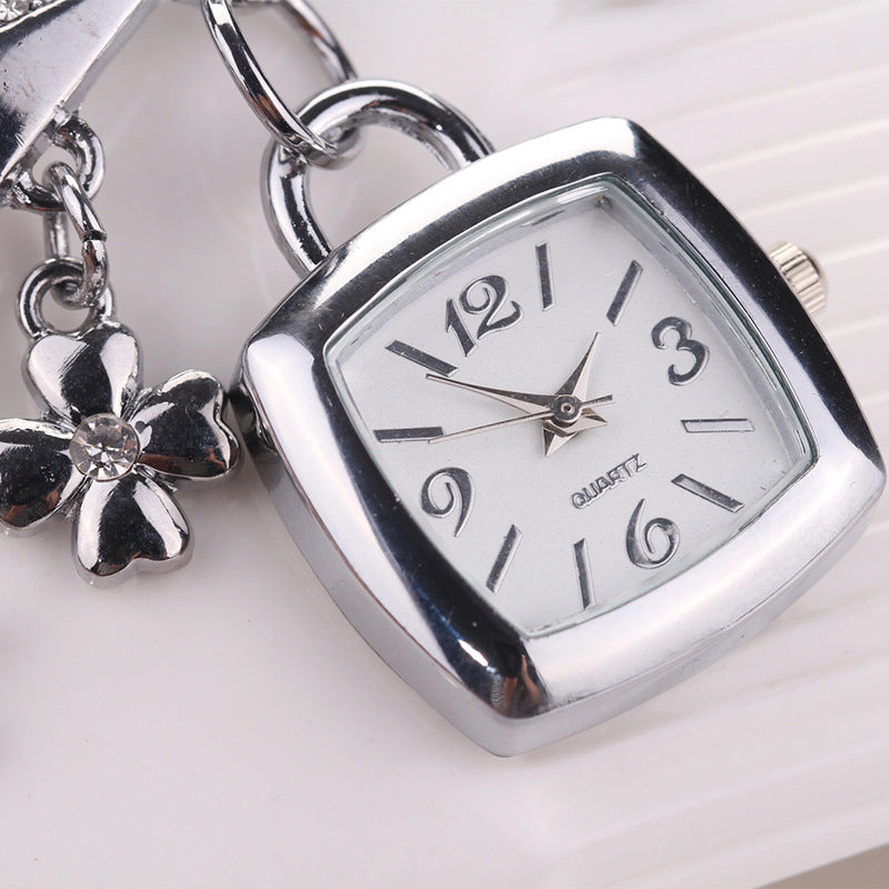 Exquisite LOVE Alphabet Bracelet Watch for Women - Quartz Movement with Flower Decor and Tonneau Dress Design - Perfect for Casual and Formal Occasions