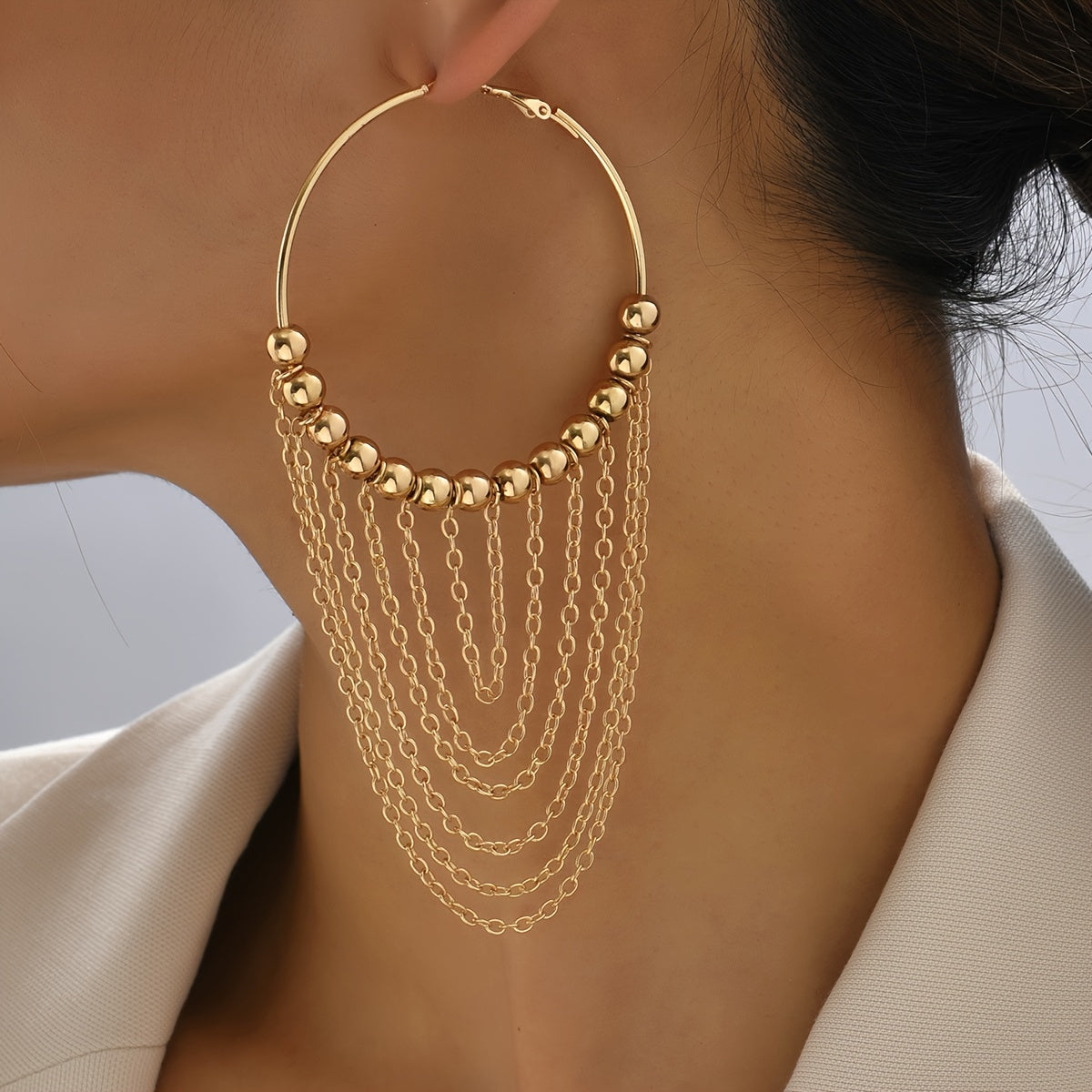 A Pair of Golden Circular Tassel Hoop Earrings